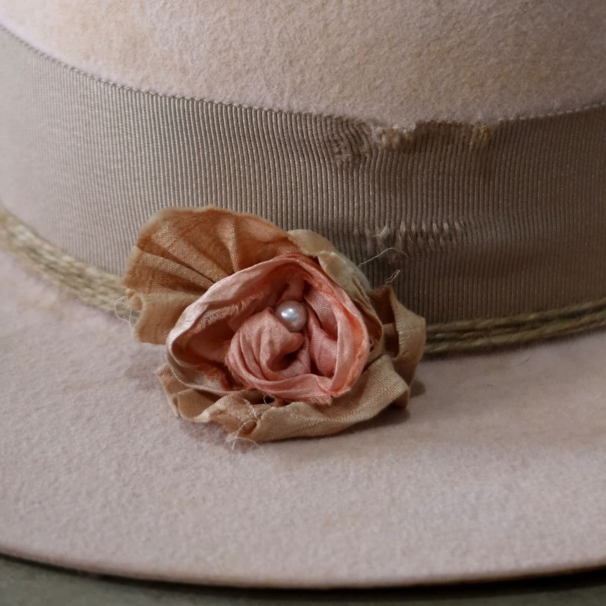 Close up detail of the Pink Bloom felt hat showing sari silk lapel bloom with pearl centre.