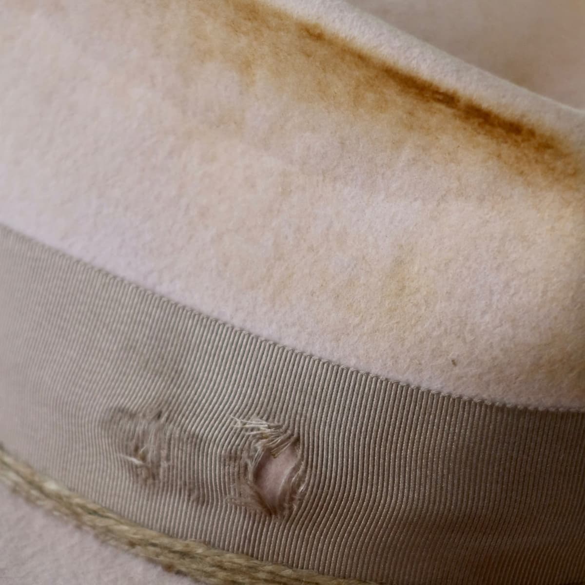 Close up detail of the Pink Bloom felt hat showing distressed baby pink felt and twine wraps.