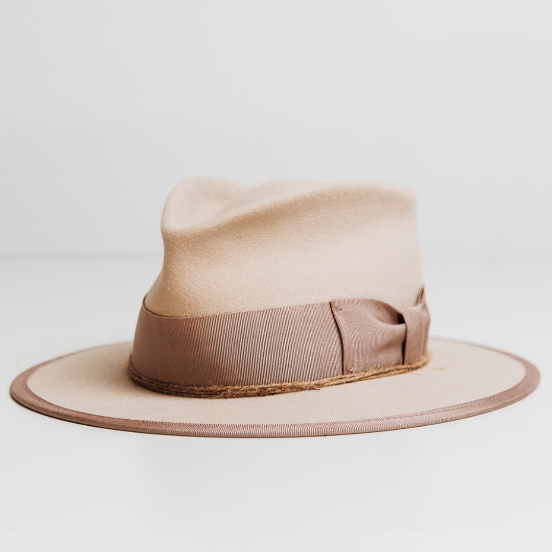Front left angle of the Plaster beige felt hat by PHYLLi Designs with plaster grosgrain bow band and twine wrapping.