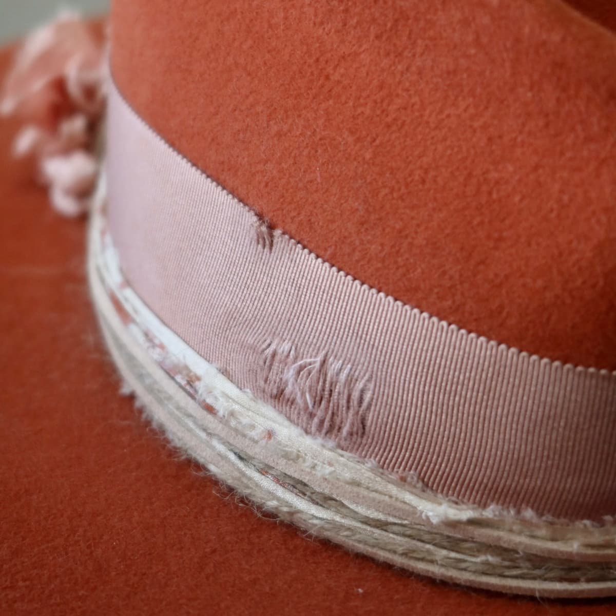 Close up detail of the Pumpkin Bloom felt hat showing distressed dirty rose Japanese grosgrain bow band.