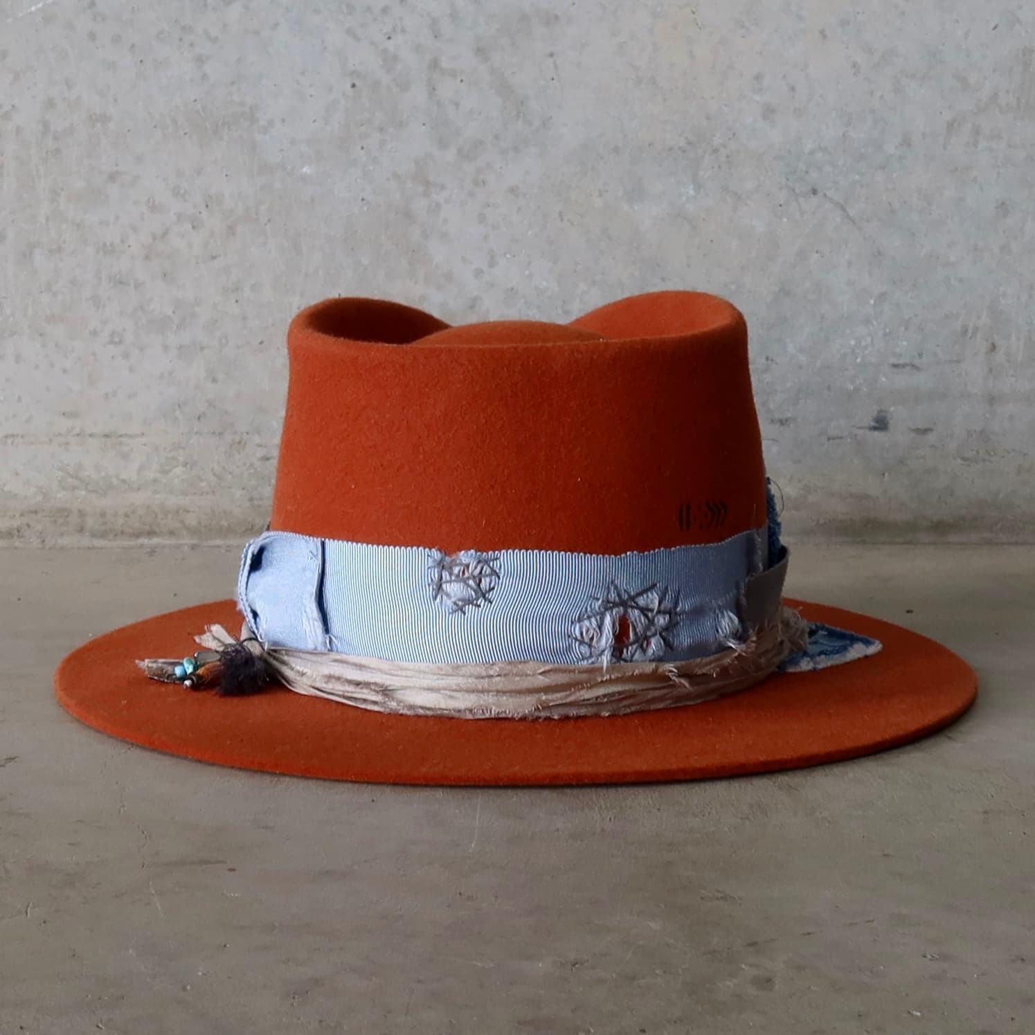 Back view of the Road Less Travelled spiced pumpkin felt hat by PHYLLi Designs featuring Wabi Sabi and worn denim patchwork.