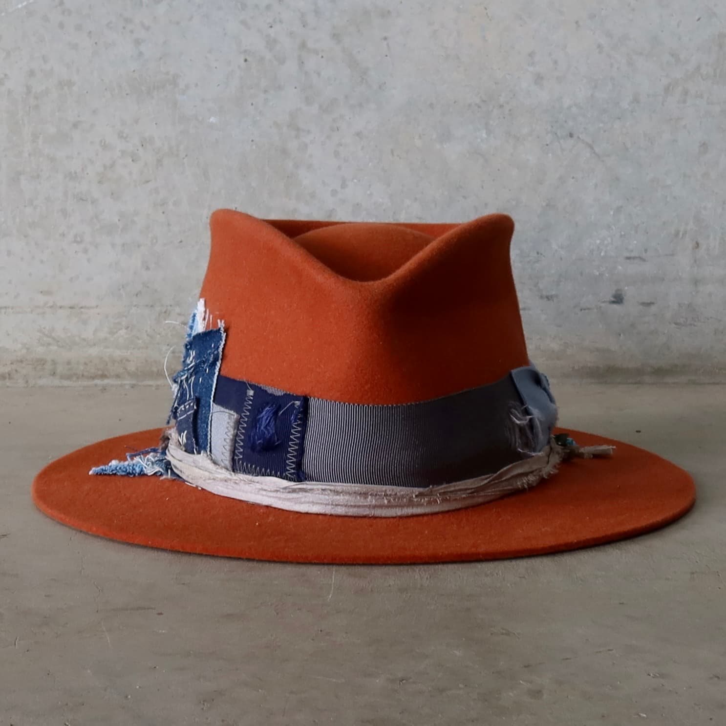 Road Less Travelled spiced pumpkin felt hat by PHYLLi Designs with distressed cornflower, cement and dark navy grosgrain bow band.
