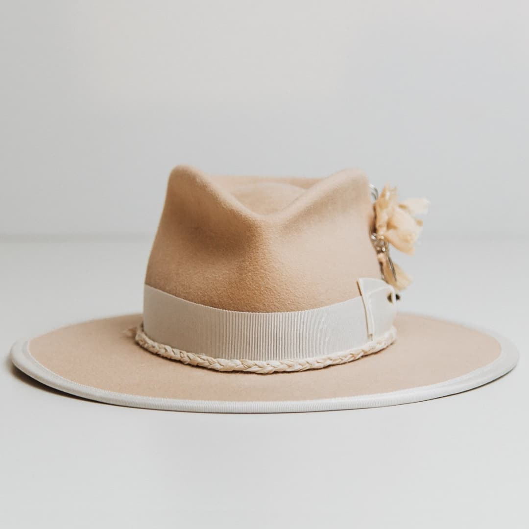 Rue De Seine beige felt hat by PHYLLi Designs with ivory Japanese grosgrain double bow band, plaited sari silk trim and silver chunky hat pin with tassel.
