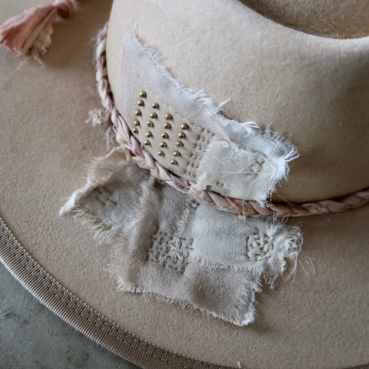 Close up detail of the Ryoan Limited Edition felt hat showing Wabi Sabi linen patches with hand stitching and gold bead detailing.