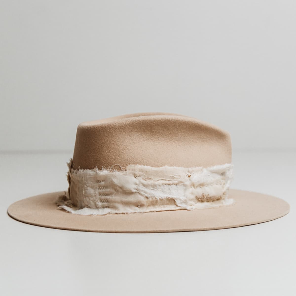 Right side view of the Sabi Limited Edition Beige felt hat by PHYLLi Designs showing sashiko stitched patch band with matte gold beading.