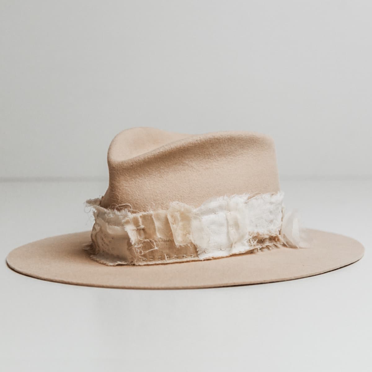 Front left angle of the Sabi Limited Edition Beige felt hat by PHYLLi Designs with Wabi Sabi patch band and sashiko stitching.
