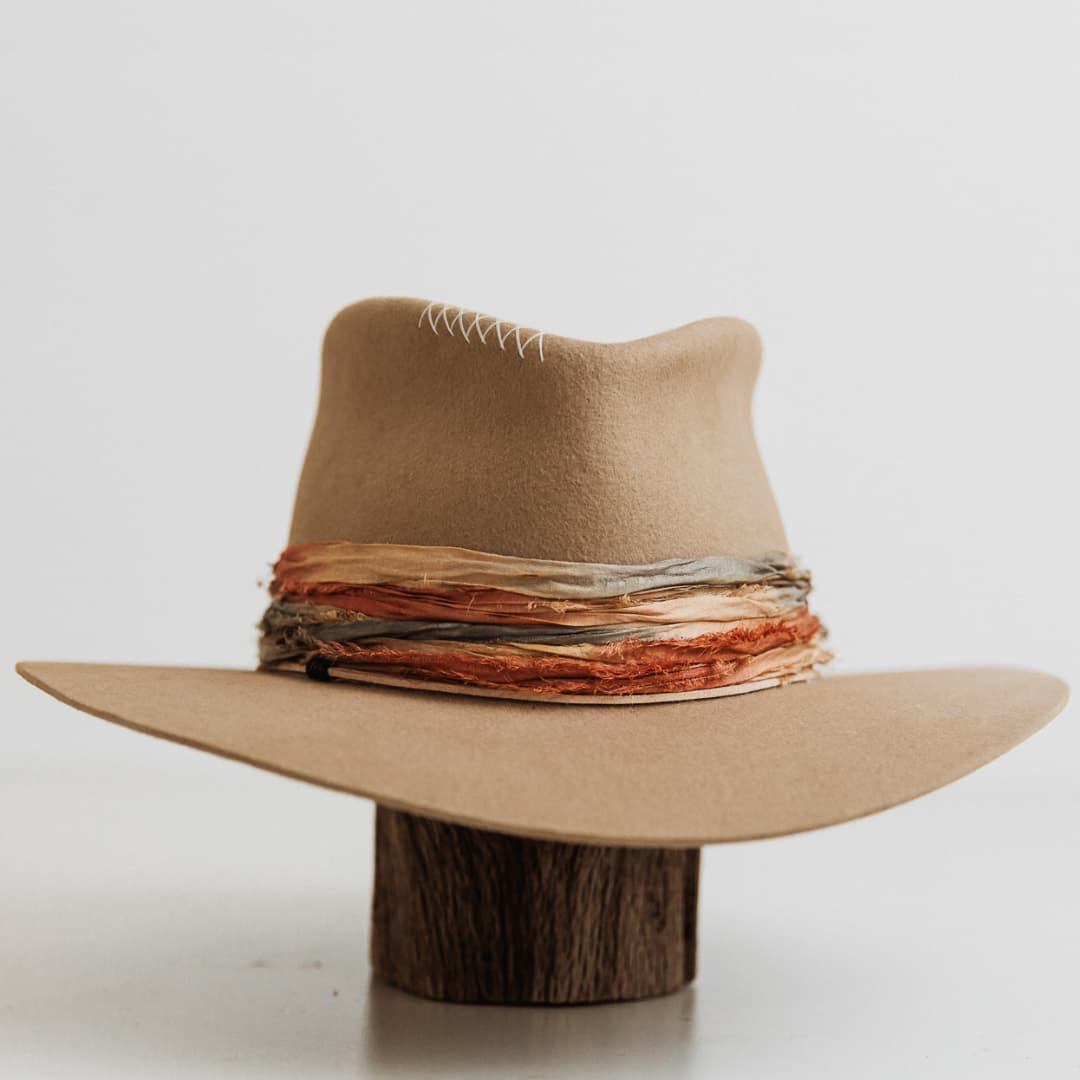 Santa Fe Autumn premium felt hat in Sahara with mushroom Japanese grosgrain band and amber, gold and jewel blue tie dye sari silk trimmings.