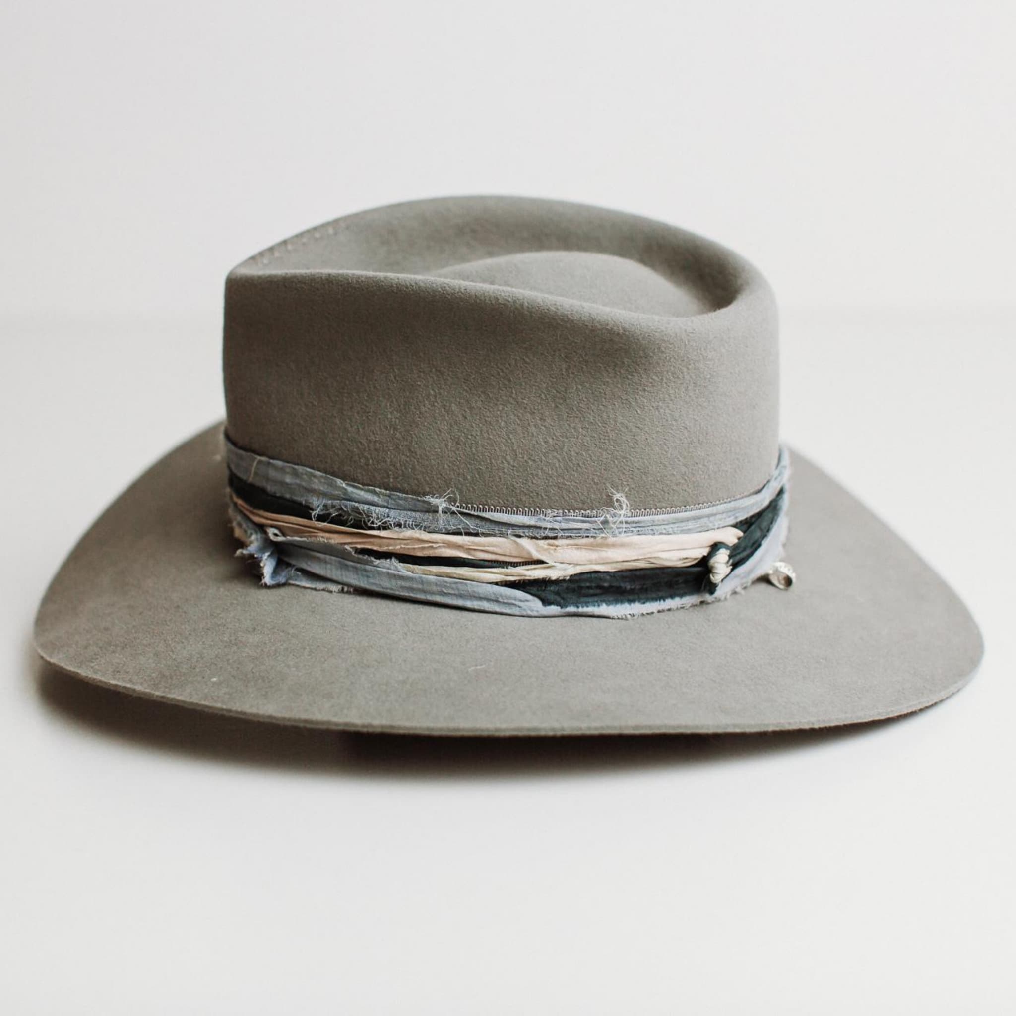 Left side view of Santa Fe Winter felt hat by PHYLLi Designs with sari silk trim in teal, storm blue and smoke.