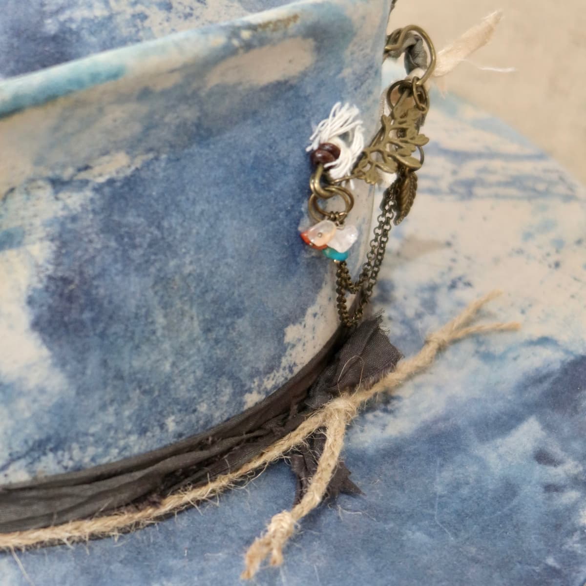 Close up detail of the Shibori Limited Edition felt hat showing layered sari silk trimming.