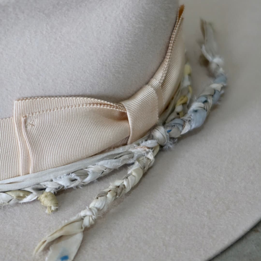 Close up detail of the Shoalhaven felt hat showing the sand Japanese grosgrain double bow band.