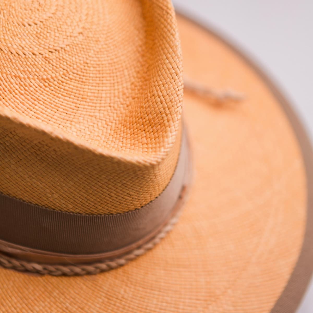 Close up detail of the Taupetone Panama hat showing handwoven toquilla straw texture and taupe Japanese grosgrain brim trim.