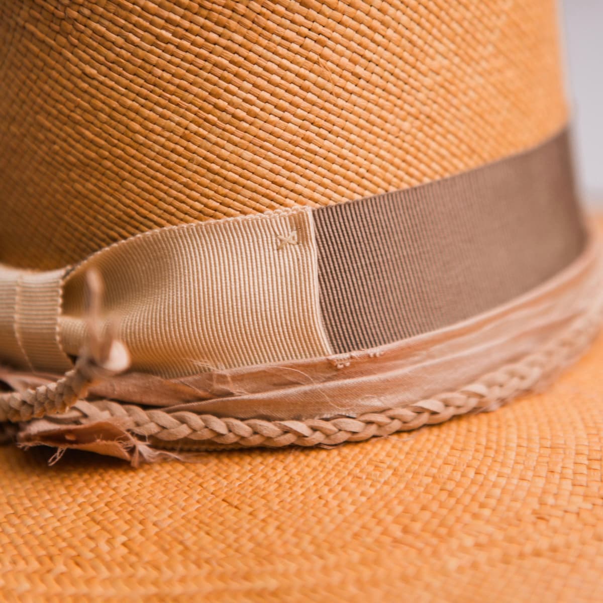 Close up detail of the Taupetone Panama hat showing taupe Japanese grosgrain band and layered sari silk trim.