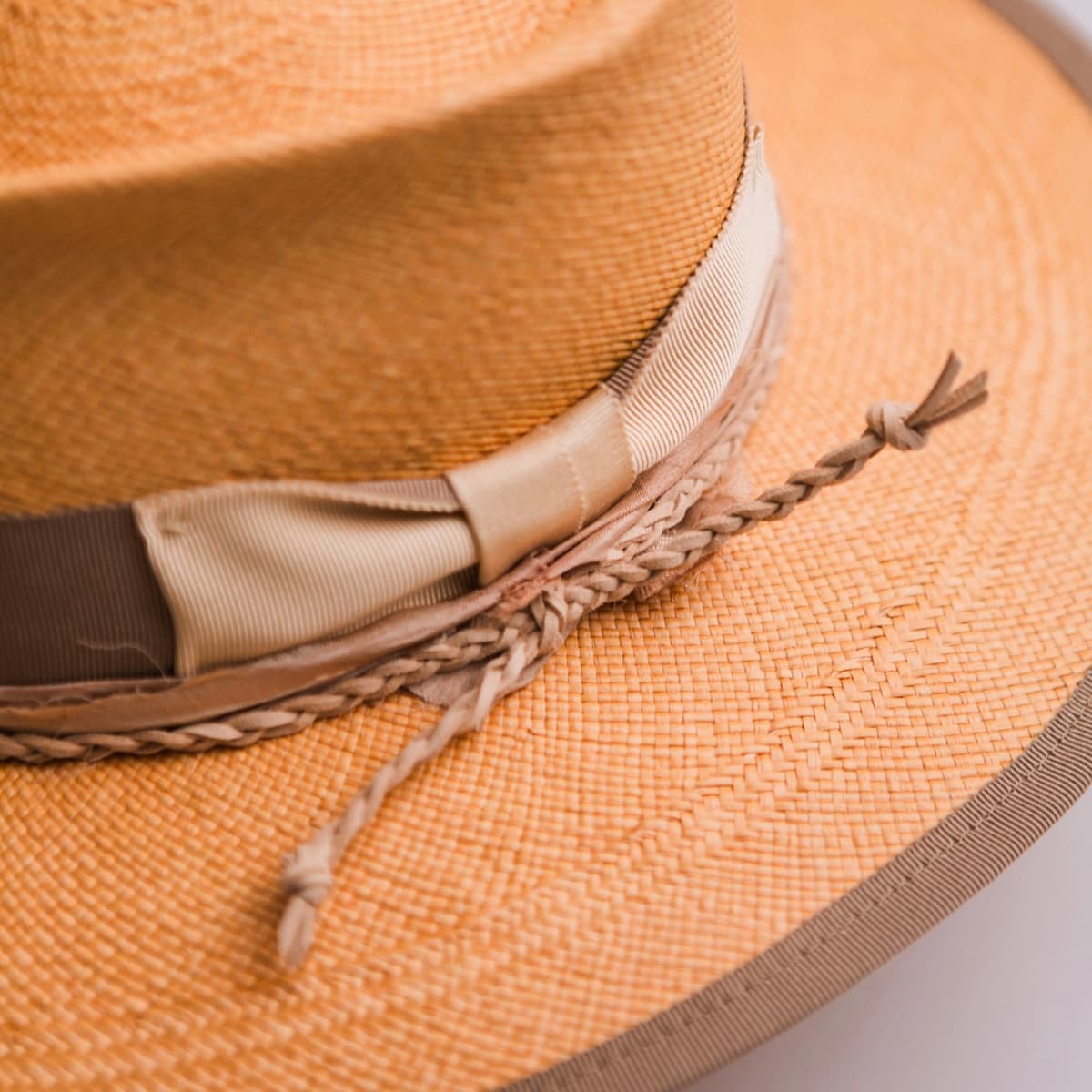 Close up detail of the Taupetone Panama hat showing sand grosgrain bow with nude sari silk trim and plaited suede string.