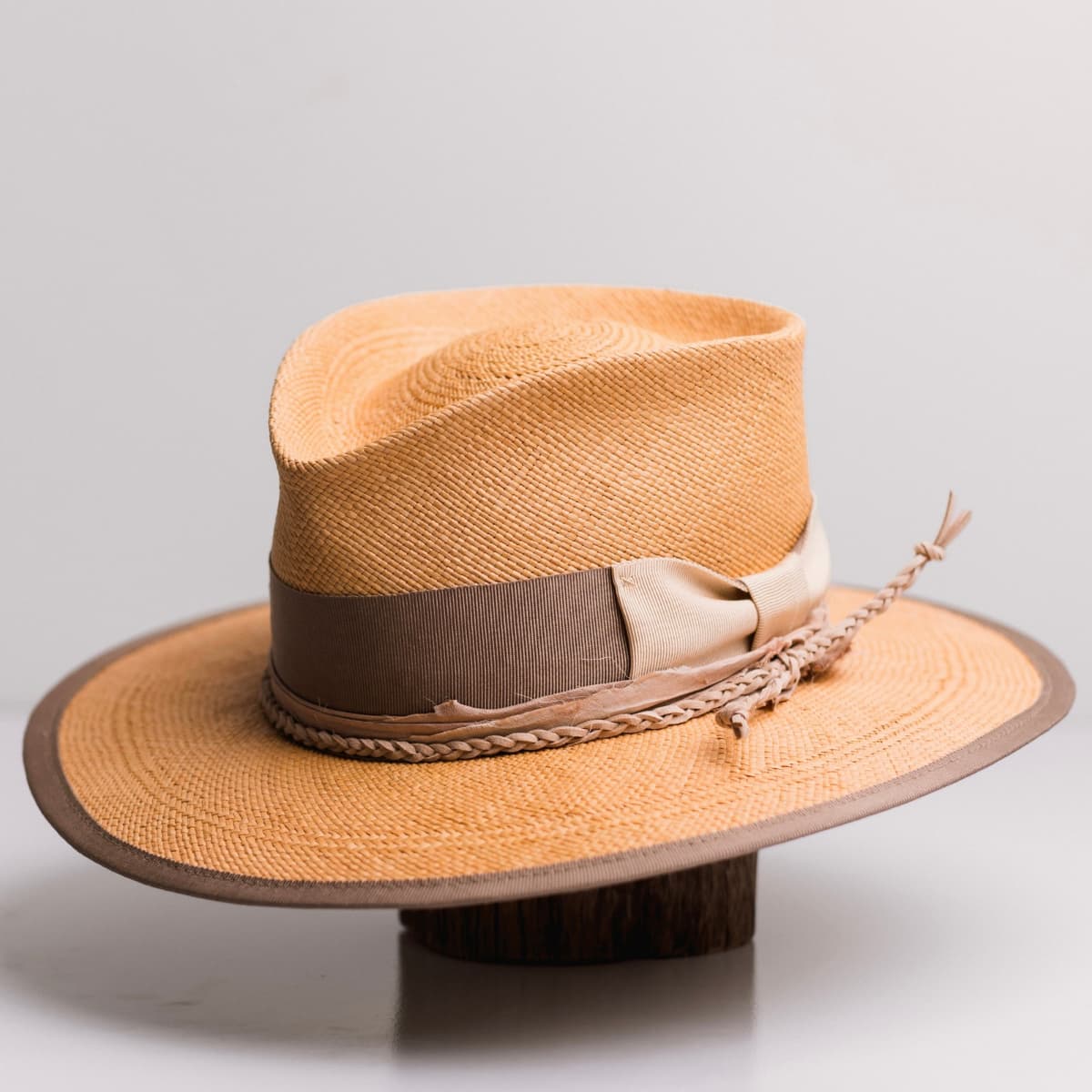 Front left angle of the Taupetone Biscuit Panama hat by PHYLLi Designs with taupe Japanese grosgrain band, sand bow and nude sari silk trim.