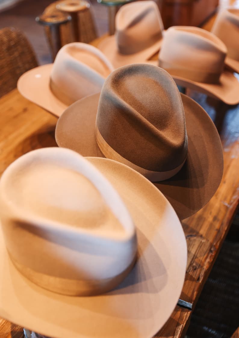 Assorted colourways of the TCMF Wheeler western felt hat by PHYLLi Designs displayed together on a wooden table.