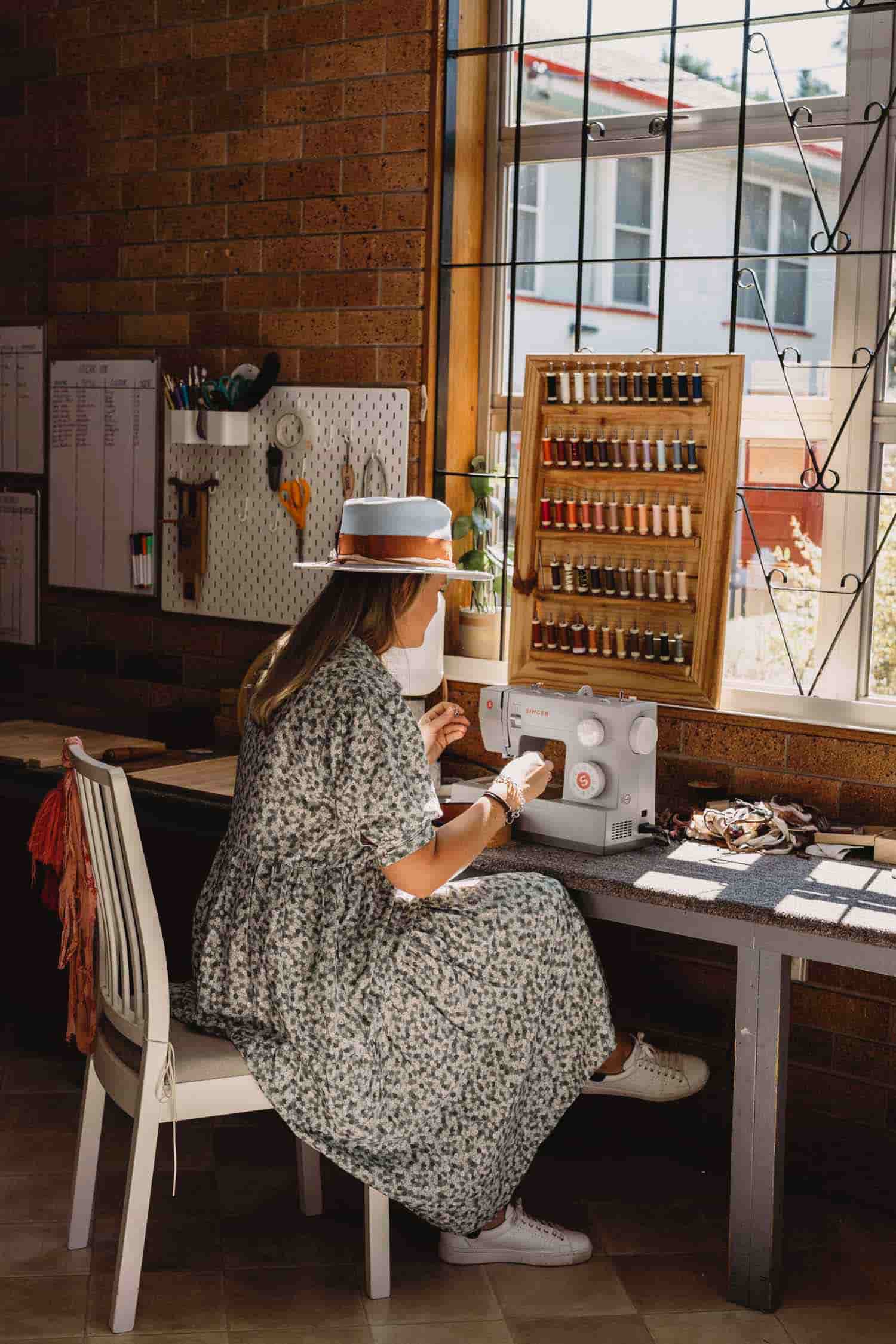 Laura Hall sewing hat components in the PHYLLi Designs production studio in regional Australia.