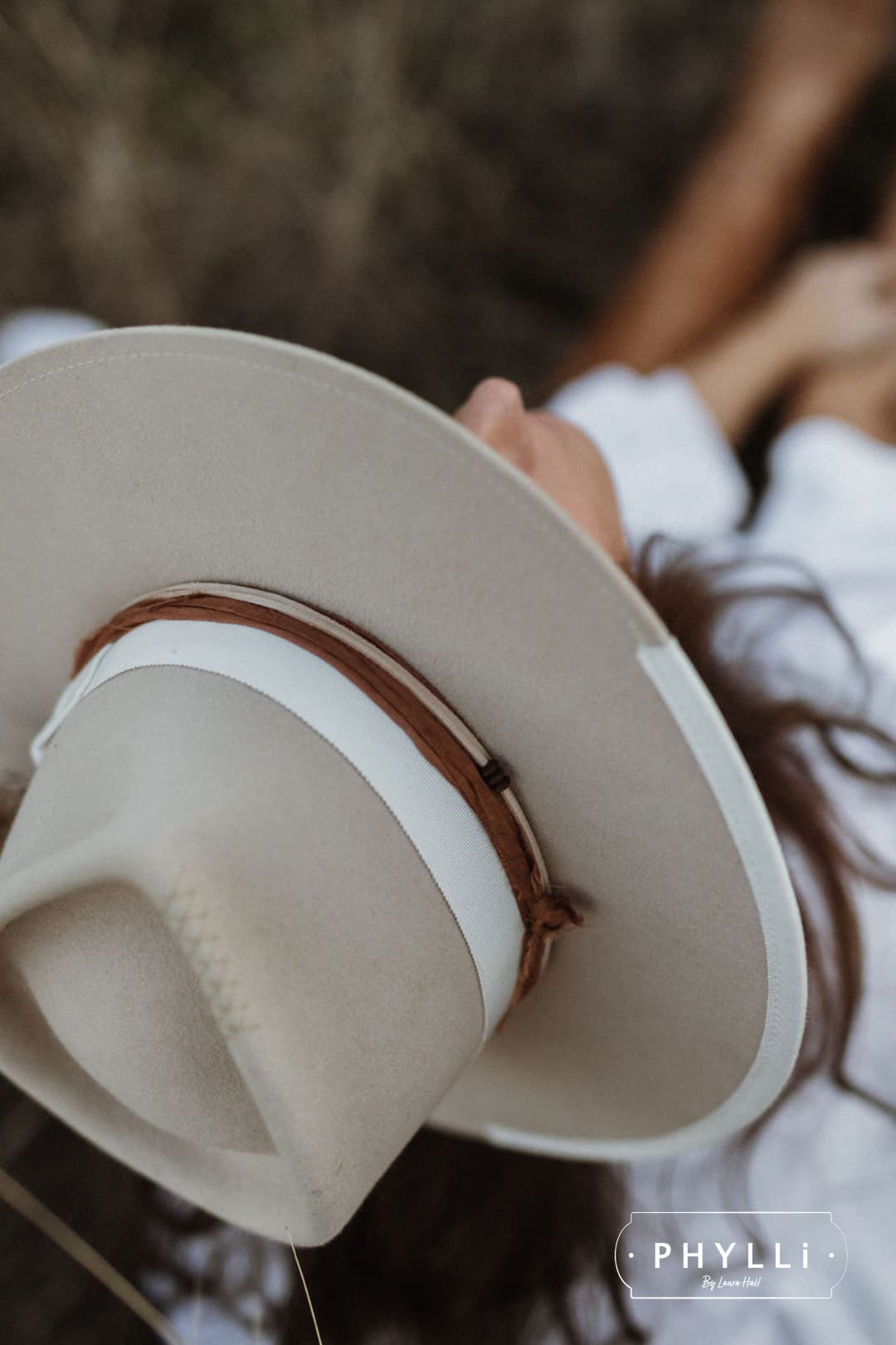 Close up of The Dartbrook beige felt hat showing ivory grosgrain band and rust sari silk trim.