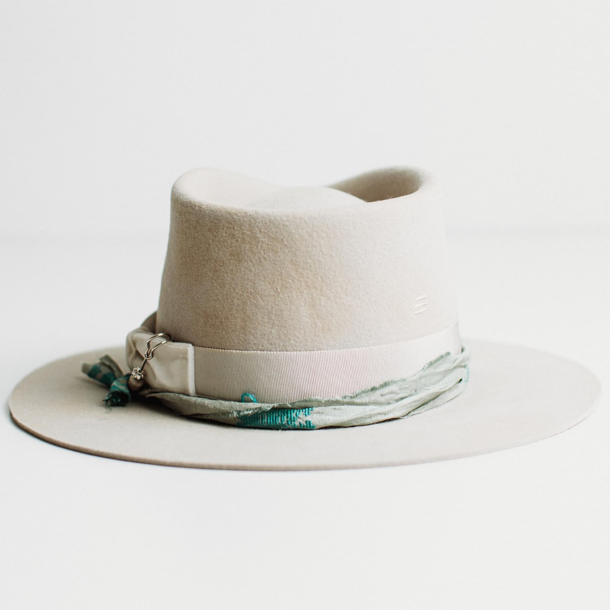 Back view of The Dove dove felt hat with grosgrain band, sari silk trim and hand-stitched ivory detail.