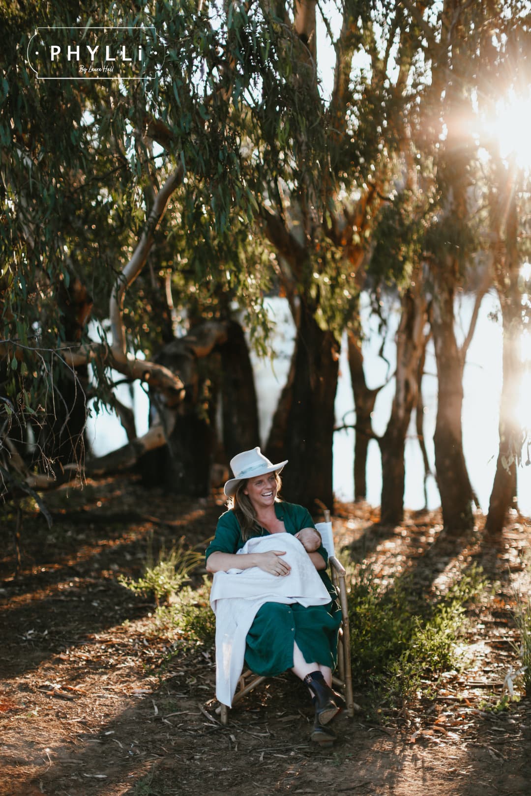 Woman relaxing outdoors wearing The Dove felt hat with blue teal sari silk trim by PHYLLi Designs.