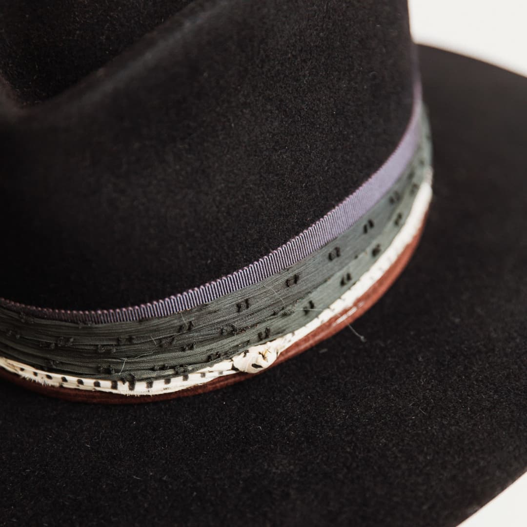 Detail of chocolate suede string with wooden beading on The Ellerston navy rabbit felt hat.