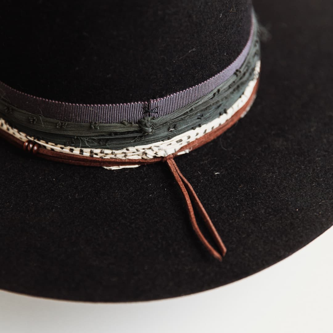 Close up of textured charcoal and cream sari silk trim on The Ellerston navy felt hat.