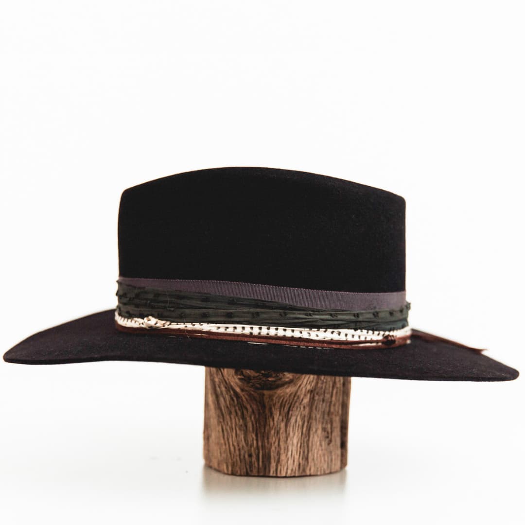 Left side view of The Ellerston navy felt hat with layered sari silk trim and chocolate suede string.