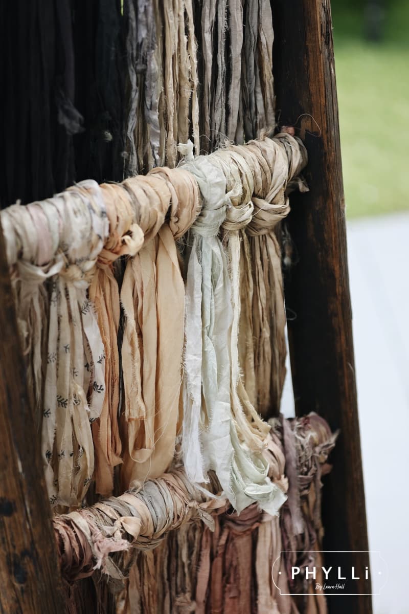Sari silk ribbons and trims hanging ready for guests to customise hats at a PHYLLi hat party.