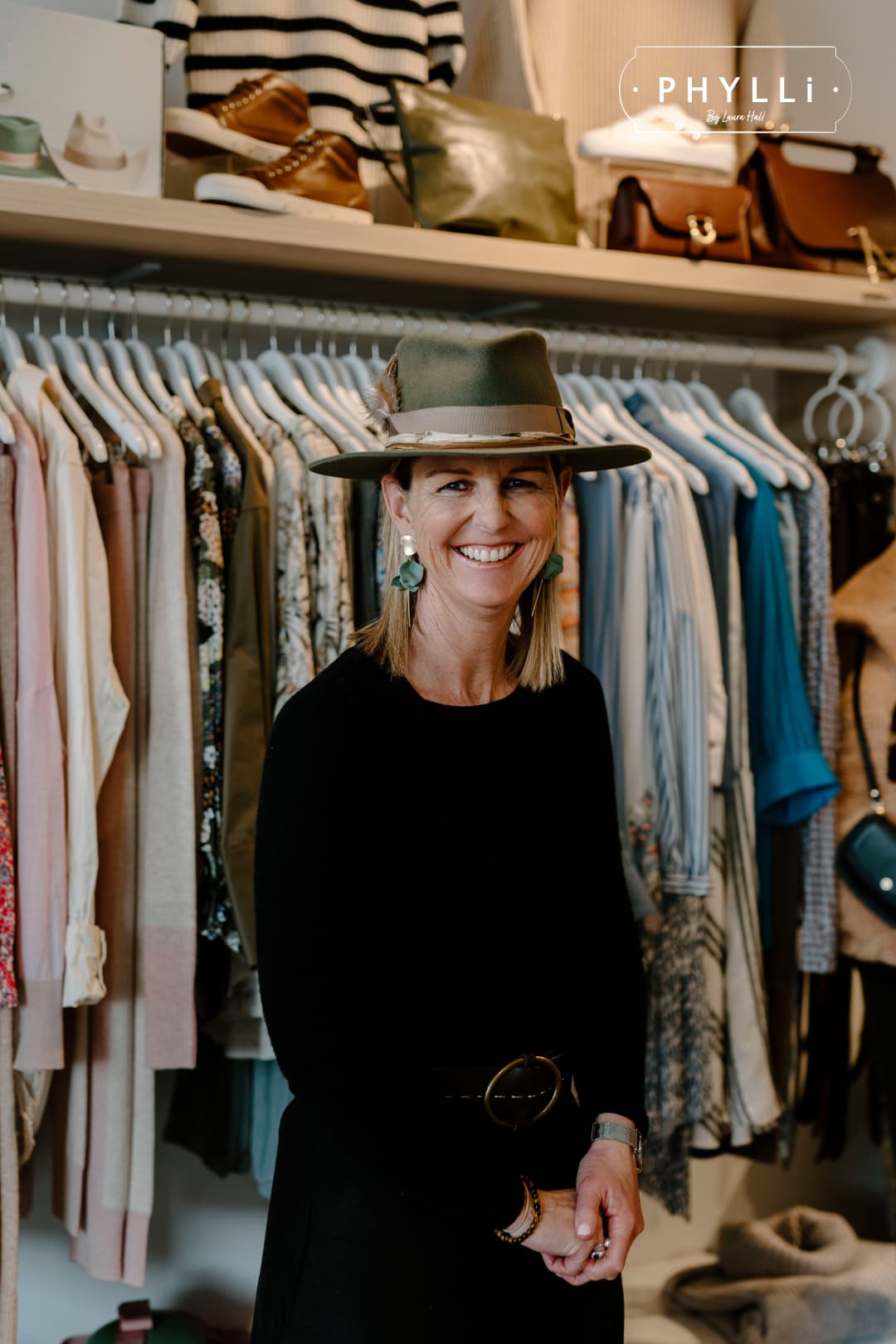 Woman wearing The Lotus Military felt hat by PHYLLi Designs inside a boutique clothing store.