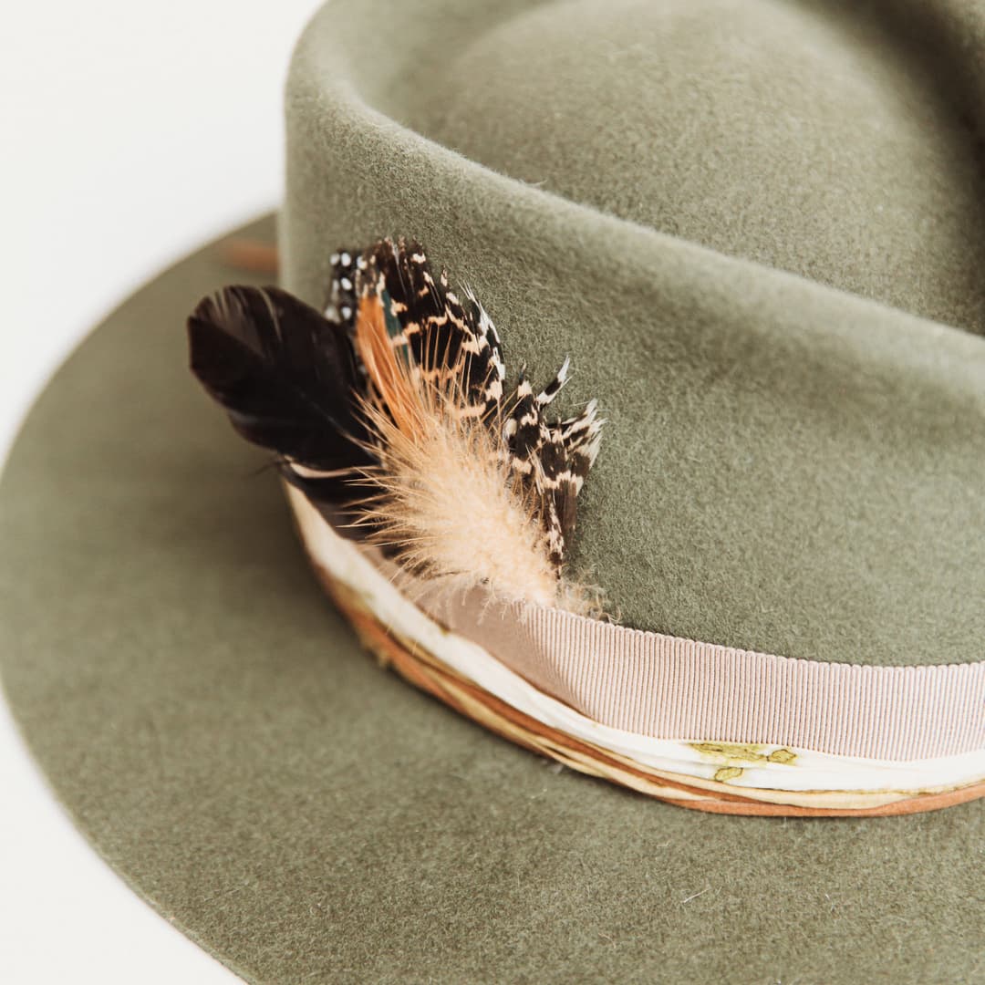 Close up of feather bunch and sari silk trim on The Lotus Military felt hat by PHYLLi Designs.