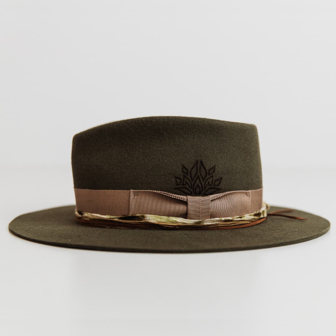 Left side view of The Lotus Military felt hat by PHYLLi Designs showing burnt branded lotus pattern on crown.