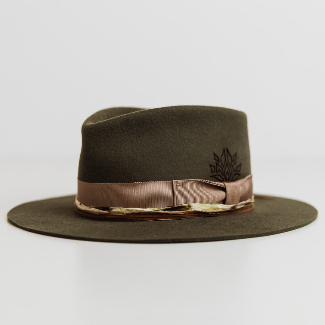 Front left angle of The Lotus Military felt hat by PHYLLi Designs featuring taupe grosgrain bow band and branding detail.