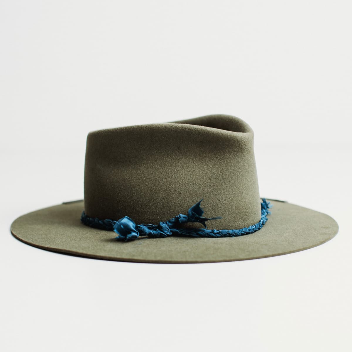 Front right angled view of The Old Man military felt hat with floating bow and silk plait trim by PHYLLi Designs.