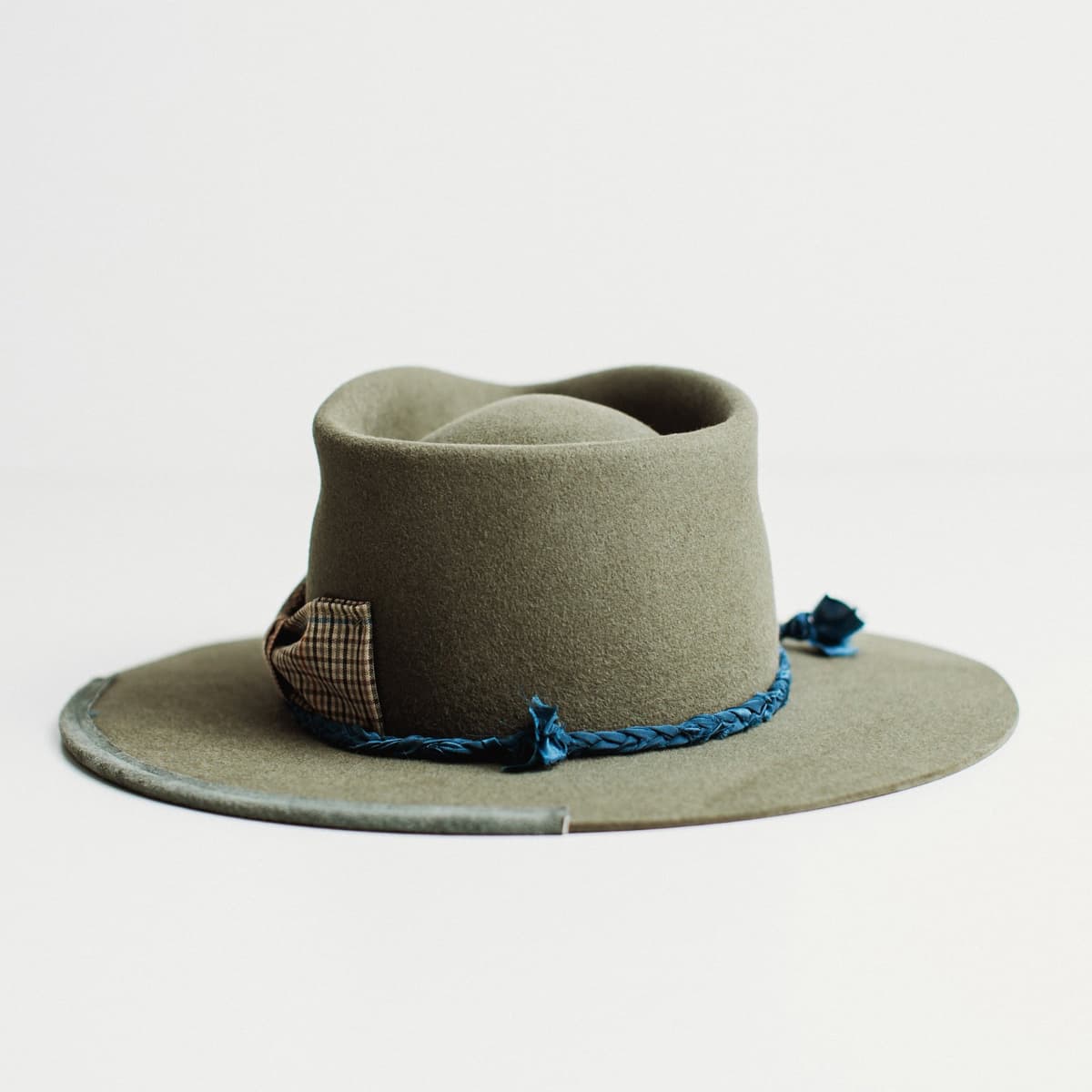 Back view of The Old Man military felt hat with silk plait trim and floating bow.
