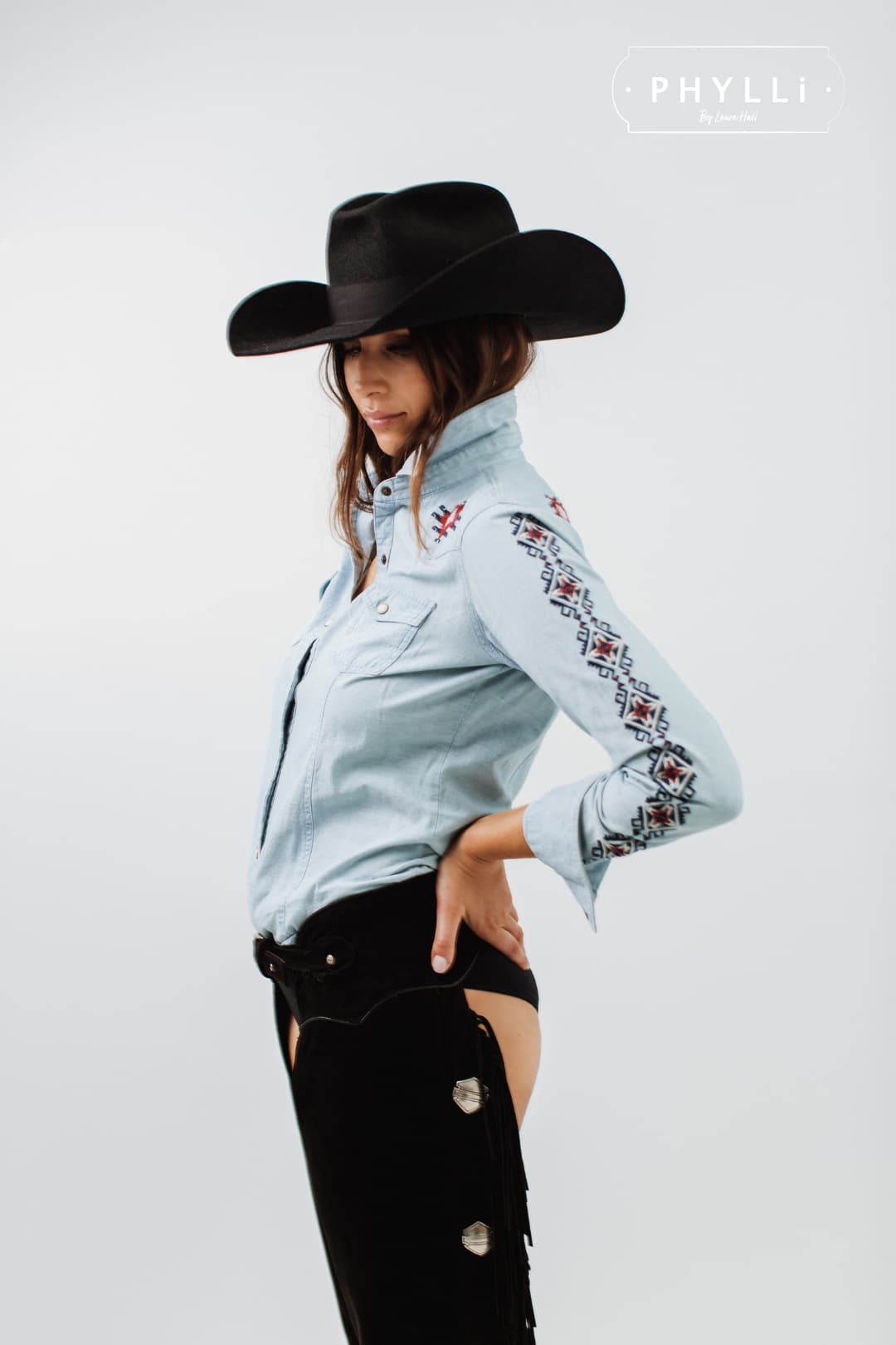 Woman wearing The Plains black felt cowboy hat by PHYLLi Designs with black Japanese grosgrain bow band.