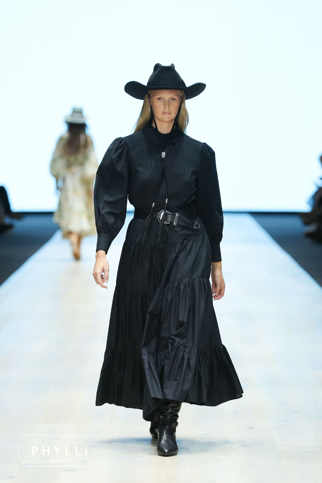 Runway model wearing The Plains black rabbit felt cowboy hat by PHYLLi Designs with wide shaped brim.