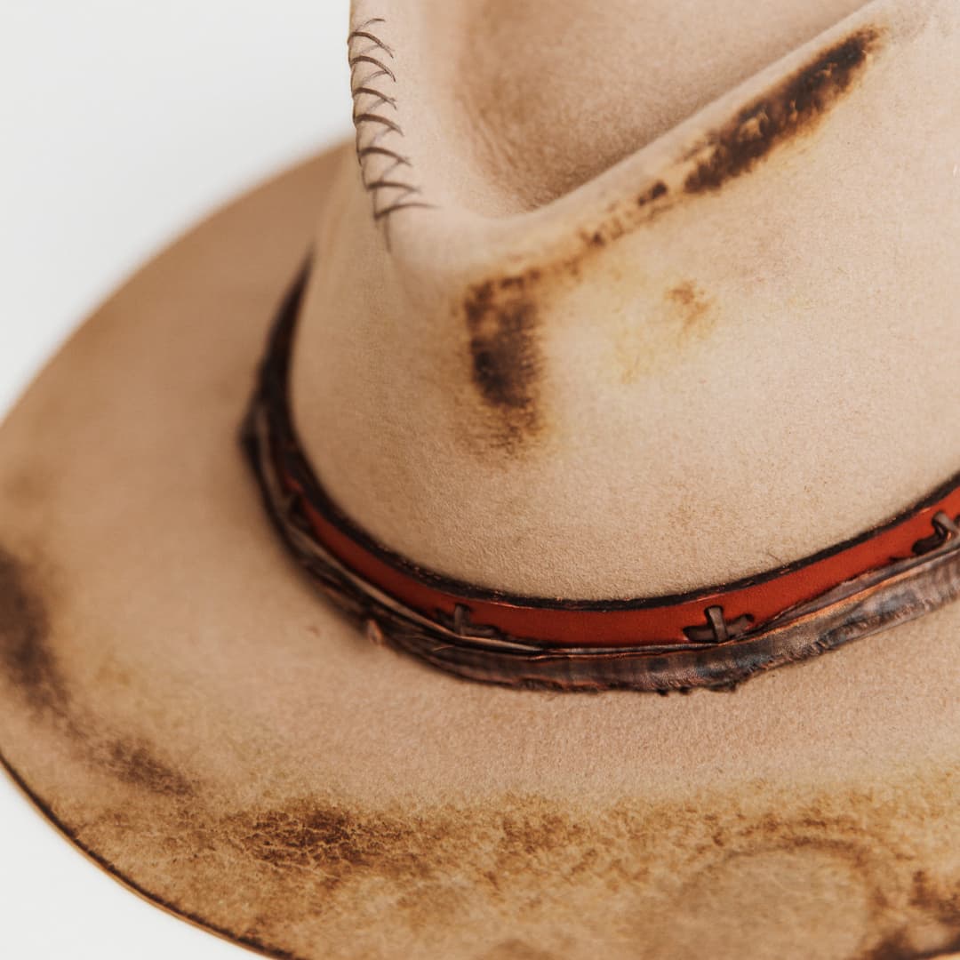 Close up of distressed Sahara felt crown showing hand-stitched crosses and weathered finish on The Safari hat.