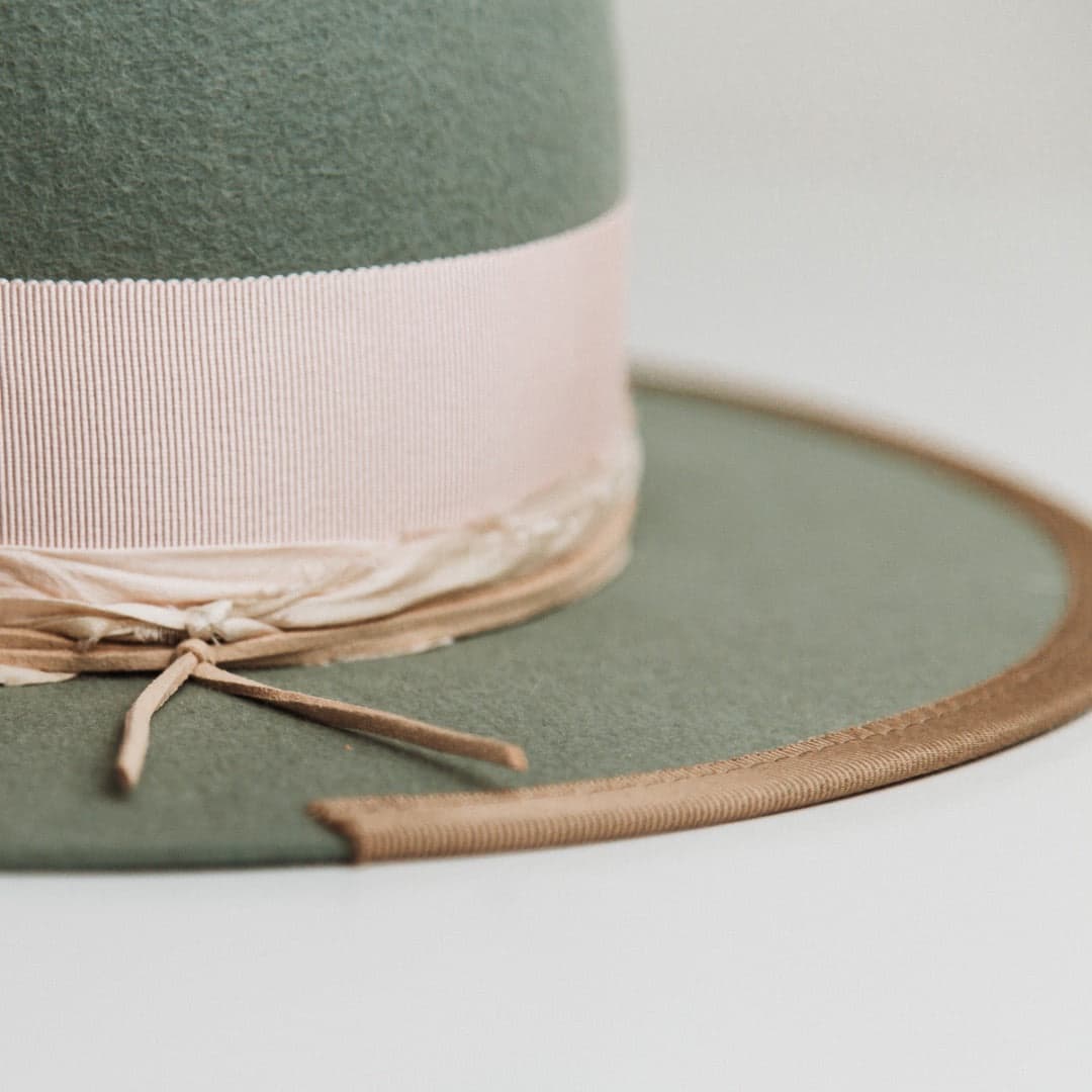 Close up detail of The Sage felt hat showing taupe 1/3 brim trim and baby pink sari silk trimming.