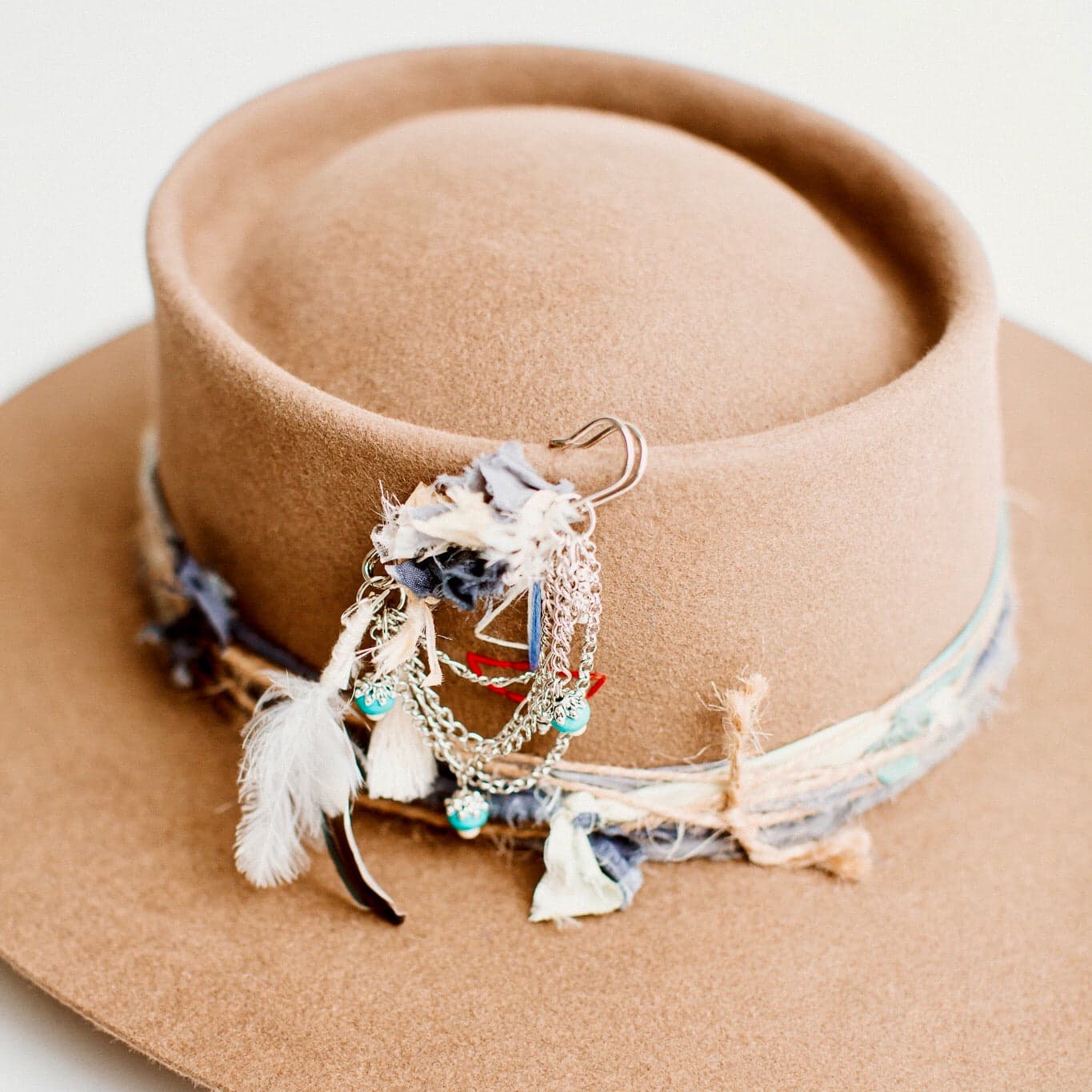 Close-up detail of The Sailer havana brown felt hat showing silk twine trim and hat pin by PHYLLi Designs.