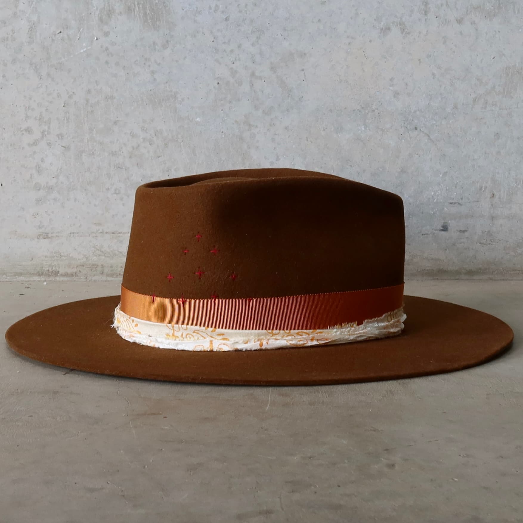 Right side view of caramel felt hat with wide brim and layered trim detail by PHYLLi Designs.