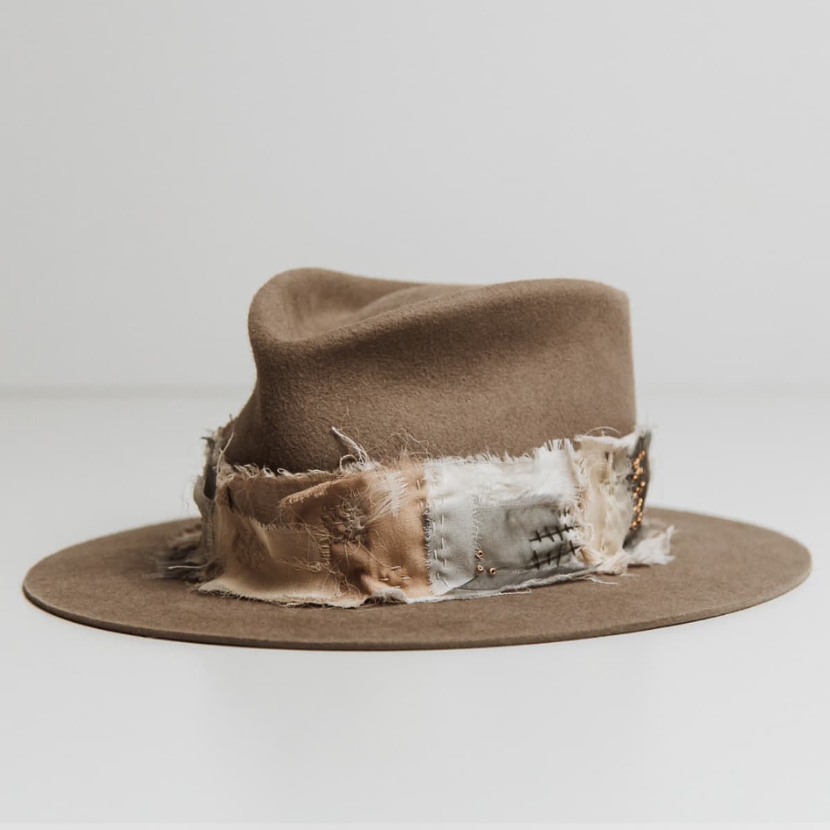 Front left angle of the Wabi Limited Edition Sahara felt hat by PHYLLi Designs with Wabi Sabi patch band and sashiko stitching.