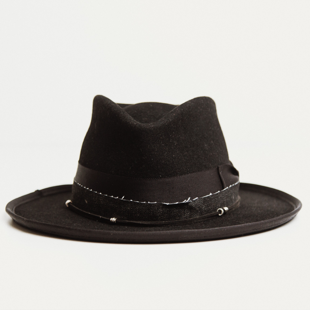 Front view - The Rocker by PHYLLi, a distressed Black felt hat with Black grosgrain bow, suede string and silver hardware.