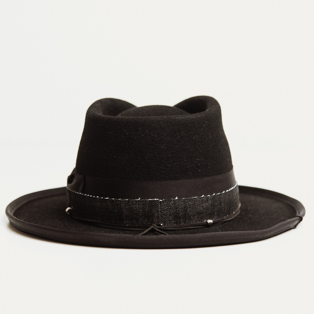 Back view - The Rocker by PHYLLi, a Black felt hat with Black grosgrain bow, 9cm curled brim, black denim and suede string.