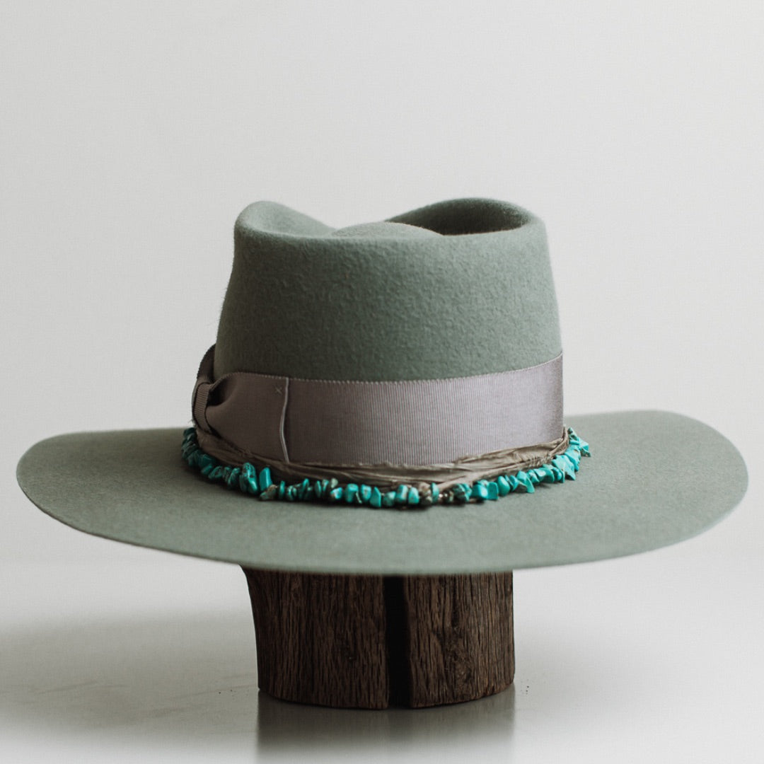 Back view of the Aurora sage felt hat by PHYLLi Designs featuring turquoise hat necklace and sari silk trimming.