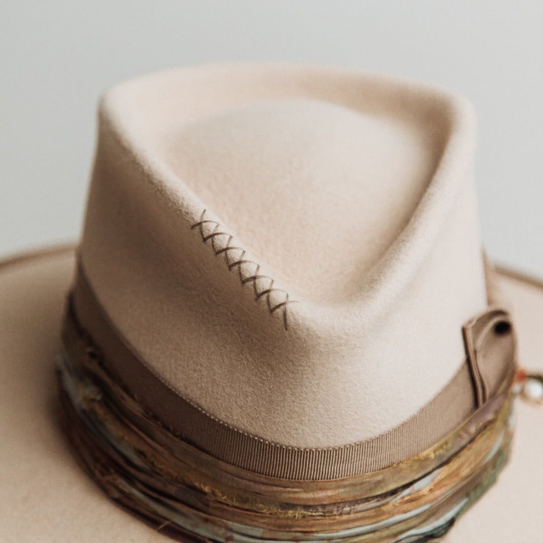 Close up detail of the Cunningham felt hat showing hand-stitched taupe crosses on the crown.