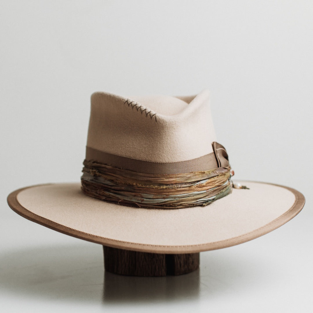 Cunningham beige felt hat by PHYLLi Designs with taupe Japanese grosgrain double bow band and jewel toned tie-dye sari silk trim.