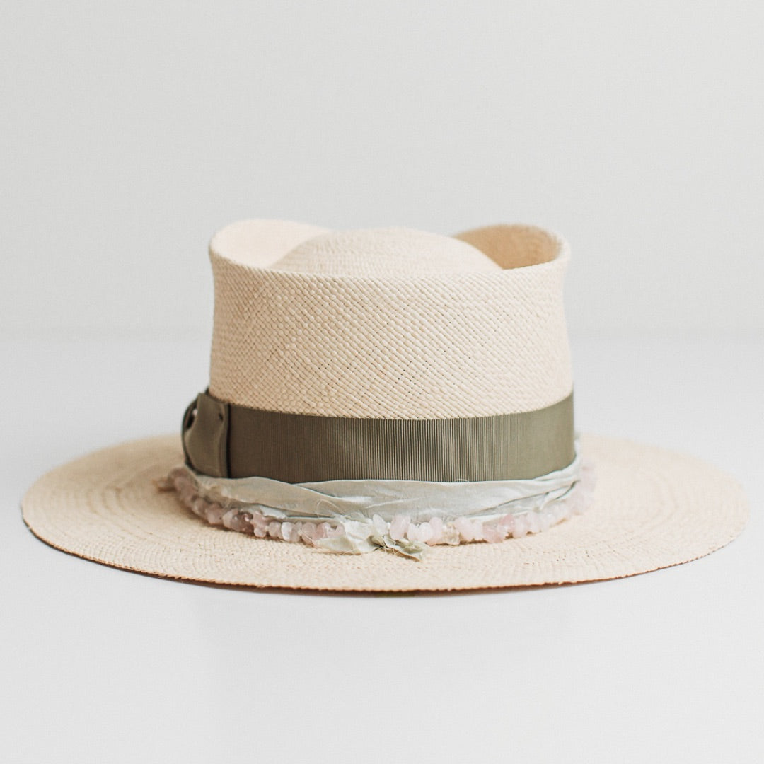 Back view of the Isle of Skye natural Panama hat by PHYLLi Designs featuring oil green grosgrain bow band and rose quartz beaded trim.