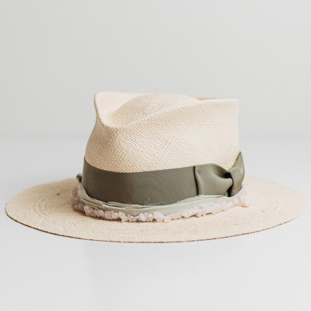 Front left angle of the Isle of Skye natural Panama hat by PHYLLi Designs with oil green grosgrain bow band and mint sari silk trimming.
