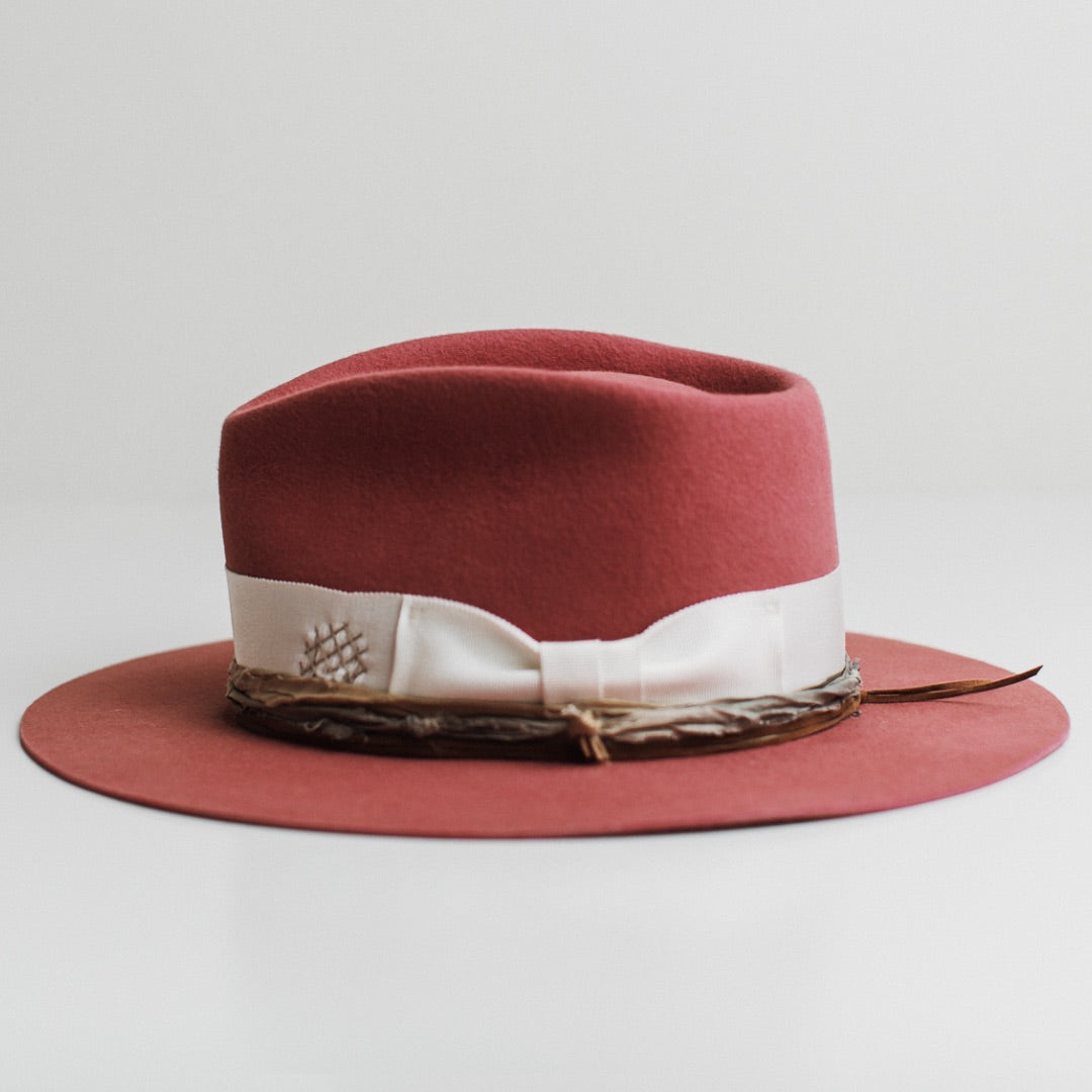 Left side view of the Kentucky rose felt hat by PHYLLi Designs with ivory grosgrain band, peach and pale blue sari silk trim and tan suede string.