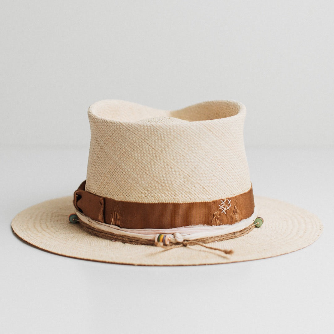 Back view of the Mango natural Panama hat by PHYLLi Designs featuring distressed copper grosgrain band with ivory darned patch stitching.