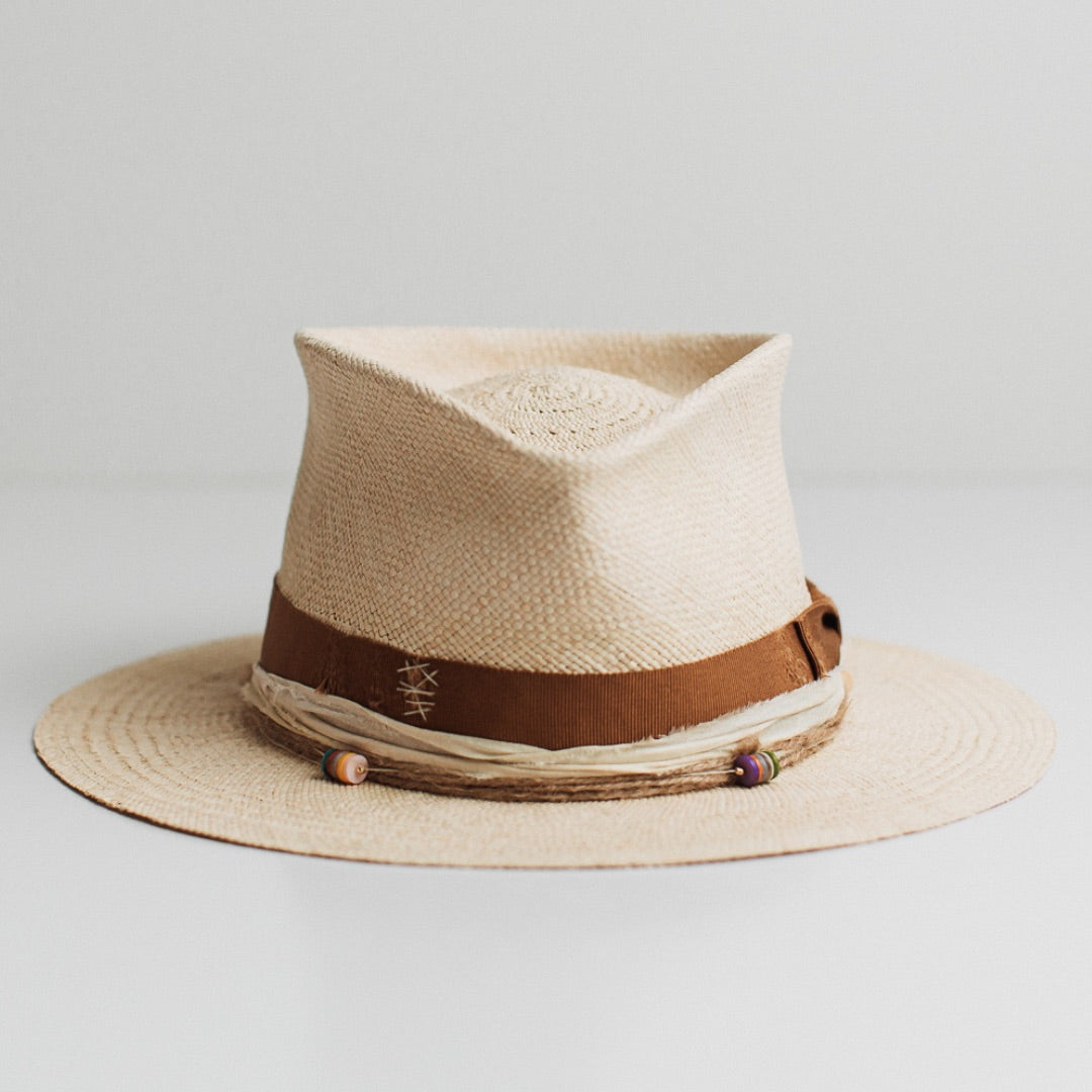 Mango natural Panama hat by PHYLLi Designs with distressed copper Japanese grosgrain bow band and twine wrap with rainbow disc clusters.